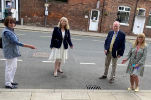 Councillor Bridget Thomas, Harriett Baldwin MP, Councillor David Chambers and town clerk Lesley Bruton check out the drains outside Tenbury’s Regal Theatre on Teme Street.